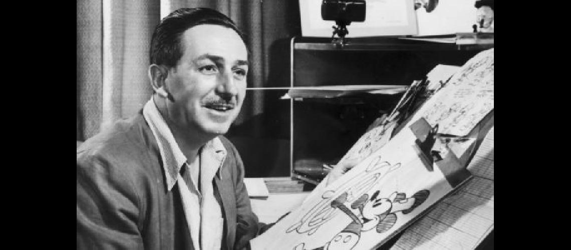 Mr Walt Disney sits at his drawing board in his studio drawing a sketch of Mickey Mouse