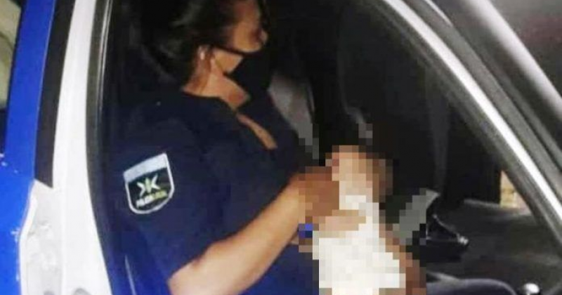 Una Policía Local con la bebé después de ponerla a salvo