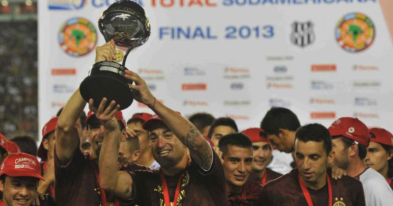 Somoza y Silva levantan el trofeo conseguido en 2013
